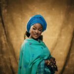 Portrait of an elegantly dressed woman in vibrant Nigerian traditional attire, showcasing grace and culture.